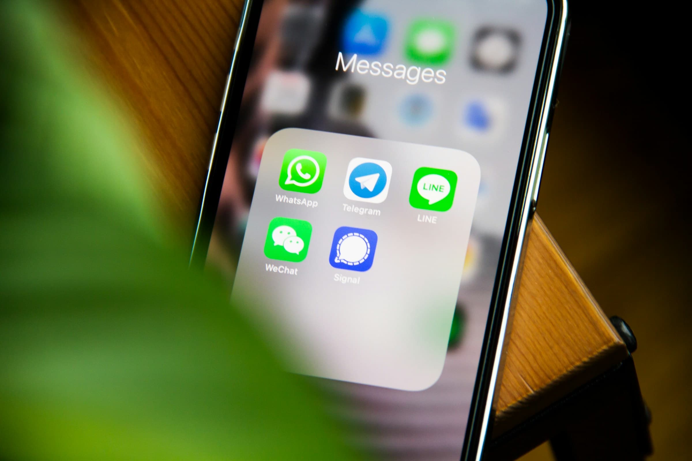 Person holding a smartphone displaying social media apps